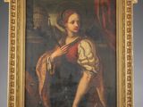 an old painting of a woman holding a dog on a easel