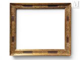 a gold picture frame on a white wall with a white background