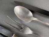 a knife, fork, and spoon sitting on a table