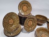a lot of plates and bowls that are sitting on a table