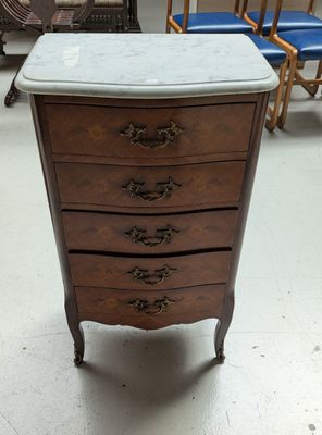 a marble top chest of drawers on display in a store