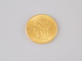 an image of a close up of a gold coin on a white surface