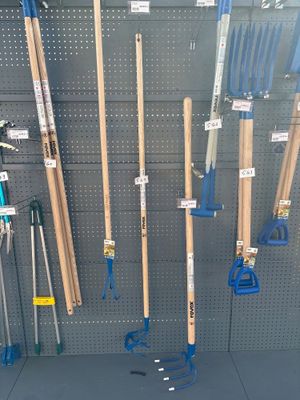 a lot of tools hanging on the wall in the store