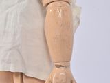 a wooden dummy with a white shirt on it ' s chest