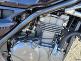 a close up of a motorcycle parked in a parking lot
