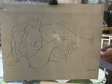a drawing of a woman holding a child on a piece of paper