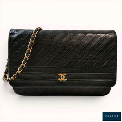 a close up of a black purse with a chain around it
