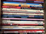 a lot of children ' s books stacked on a shelf