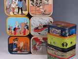 several tinned tinned containers with cartoon characters are stacked on top of each other