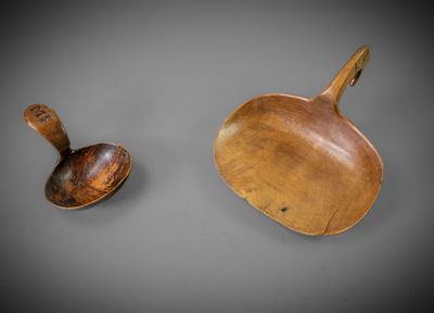 two wooden spoons and a wooden spoon on a gray surface