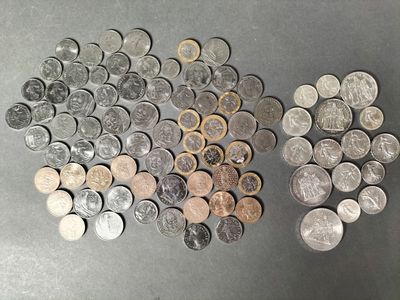 a bunch of coins sitting on top of a table next to each other