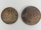 two old coins are shown side by side on a white surface