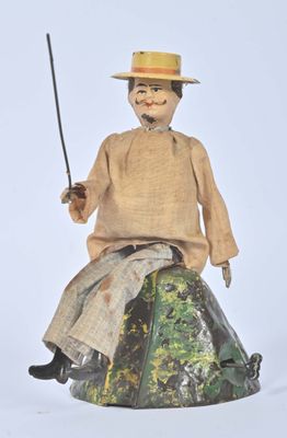 a small doll sitting on top of a rock with a sword