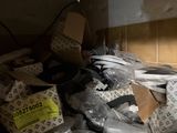 a pile of items on a shelf in a room