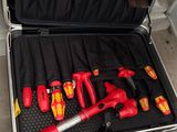 a man opening a tool case with tools in it