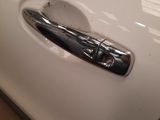the door handle of a white car with a black handle