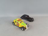 two toy cars sitting next to each other on a table