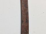 a close up of a sword on a white surface