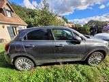 a car that is parked on the grass in front of a house