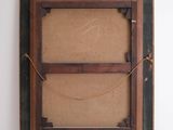 an old picture frame hanging on a wall next to a white wall