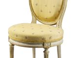 the chair is made of wood and has a yellow upholstered seat