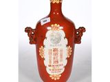 a red vase with a picture of a man on it