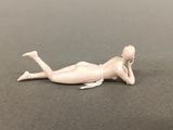 a small doll that is laying on the ground