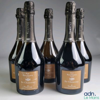 four bottles of champagne are lined up on a table