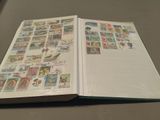 an open book with stamps on it sitting on a table