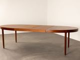 a large oval dining table with two leaves on the top
