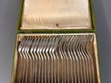 a box with a bunch of silverware inside of it