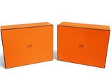 two orange boxes that are sitting next to each other on a white surface