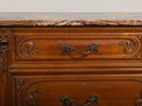 a wooden dresser with marble top on display