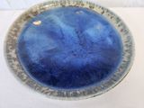a blue bowl sitting on top of a white table