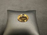 a close up of a cushion with a yellow diamond on it