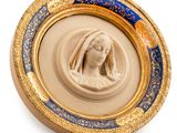 a picture of a gold and blue plate with a picture of a woman in a veil