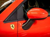 a close up of a red car with a red door handle