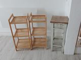 three wooden shelves in the corner of a room