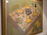 a painting on the wall of a dining room with a table and chairs