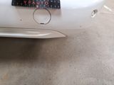 a sticker on the back of a white car