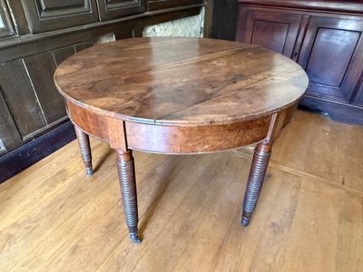 a wooden table with a wooden top on a hard wood floor