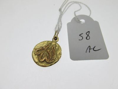 a close up of a gold coin on a string with a price tag