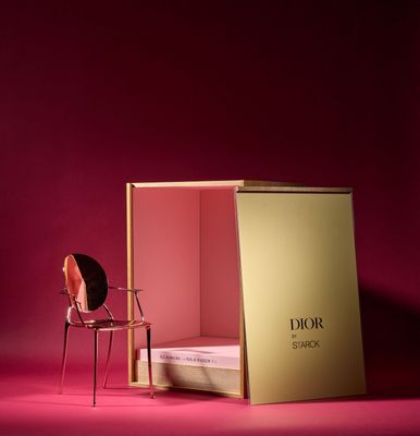 a chair and a box on a pink surface with a pink background