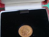 a gold coin sitting in a box on a table