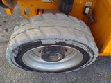 a tire on the back of a yellow truck