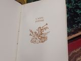 a open book sitting on a bed with a yellow ribbon around it
