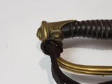 a close up of a sword on a white surface