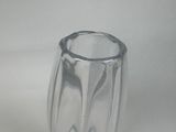 a clear glass vase with a curved design on it