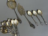 several silver spoons and spoon spoons sitting on top of a table