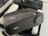 a camera sitting on top of a suitcase on a table